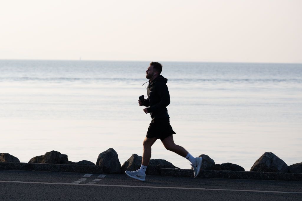 CARDIFF, UNITED KINGDOM - MARCH 24: A man runs on Cardiff Bay barrage on March 24, 2020 in Cardiff, United Kingdom. British Prime Minister, Boris Johnson, announced strict lockdown measures urging people to stay at home and only leave the house for basic food shopping, exercise once a day and essential travel to and from work. Coronavirus (COVID-19) has spread to at least 195 countries, claiming over 16,500 lives and infecting over 380,000 people. There have now been 6,650 diagnosed cases in the UK and 335 deaths. (Photo by Matthew Horwood/Getty Images)