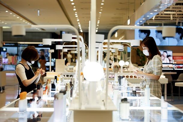 Women wearing masks to avoid the spread of the coronavirus disease (COVID-19) shop at a cosmetic shop in a department store in Seoul, South Korea, July 2, 2020. Picture taken July 2, 2020. REUTERS/Heo Ran